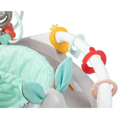 Black and white Tiny Love 4-in-1 baby walker with a patterned seat and colorful activity rings.