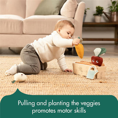 Baby plays with plush vegetables from the Tiny Love Veggie Garden set, enhancing motor skills.