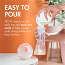 Boon TROVE silicone breast milk collection cup being poured into a storage bag, demonstrating spill prevention features.