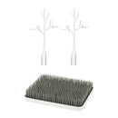 Boon LAWN drying rack featuring a gray grass-like base with two white twig accessories for effective drying.