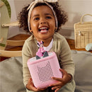 Child smiling while holding a pink Minnie Mouse audio toy figurine, featuring a speaker and playful design.