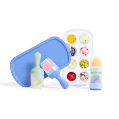 Ubbi Baby Food Feeder & Freezer Tray Set in Polaris Blue and Zest Green, featuring a tray, two feeder cups, and colorful frozen food.