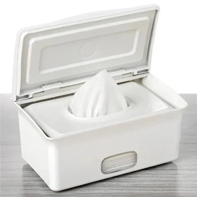 Ubbi white baby wipes dispenser with wipes partially pulled up, designed for easy access and storage.