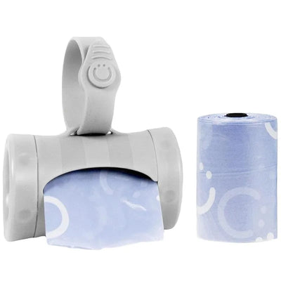 Retractable Ubbi bag dispenser in gray, with a roll of blue waste bags visible on the side.