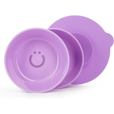 Two smooth, purple baby bowls with interchangeable suction bases, featuring a smiley face design on the interior.