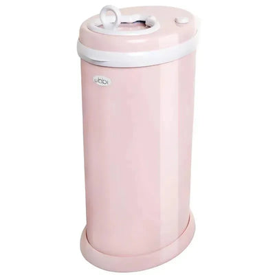 Steel odor-locking diaper pail in blush pink with a white lid and a top opening for disposal.