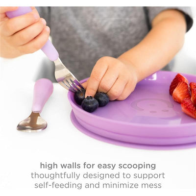Plate set in Smoothie Purple with high walls, featuring a child using a fork to scoop blueberries and strawberries.