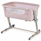 3-in-1 bedside sleeper in plum pink with mesh sides, adjustable height, and rolling wheels for convenience.