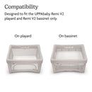 UPPAbaby 2Pk Mattress Covers displayed on a playard and a bassinet, highlighting compatibility with Remi V2 models.