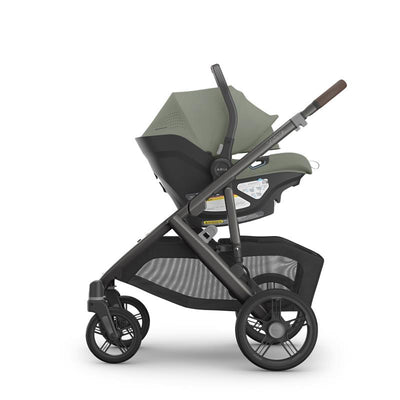 Lightweight Uppababy Aria V2 Infant Car Seat in Meadow Green, mounted on a sleek black stroller frame.