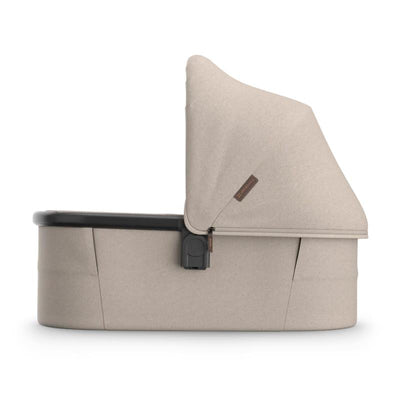 Uppababy Bassinet V3 Ada in Sandstone Melange with Chestnut Leather accents, featuring a removable canopy and sleek design.