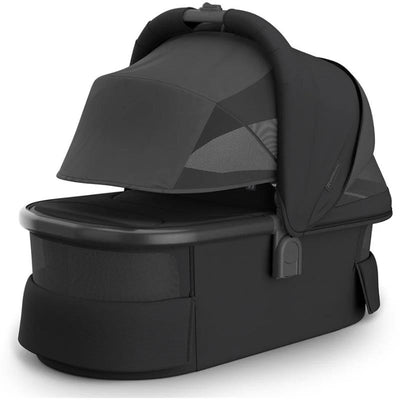 Uppababy Bassinet V3 in black with a carbon frame and leather accents, featuring a mesh ventilation and large canopy.