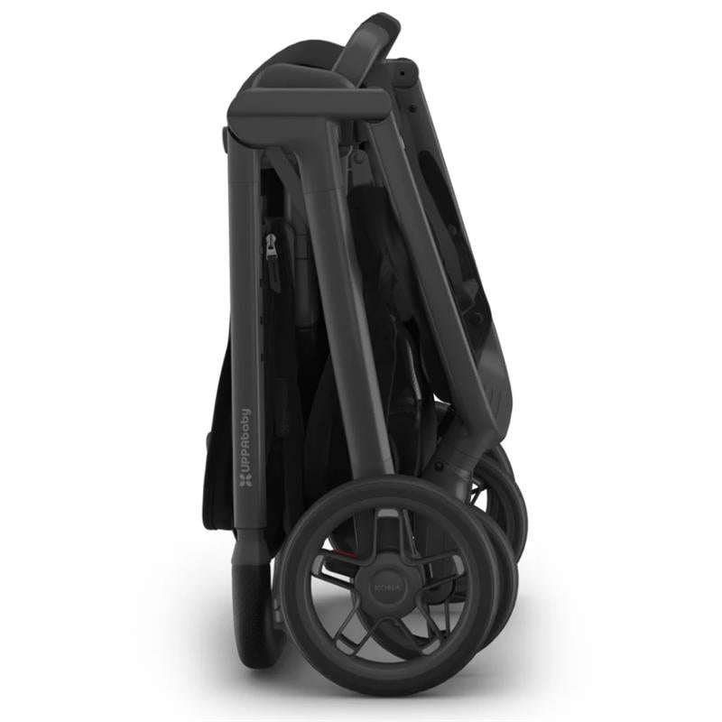 Uppababy Kona Stroller, folded position in sleek black, showcasing its compact design and sturdy wheels.
