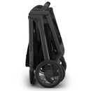 Uppababy Kona Stroller, folded position in sleek black, showcasing its compact design and sturdy wheels.