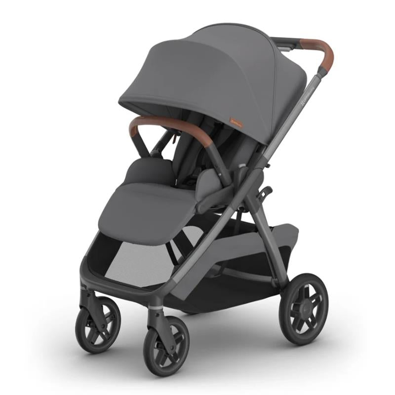 Uppababy Kona Stroller in Rowan (Graphite) color, featuring a spacious seat, large canopy, and brown handlebar accents.