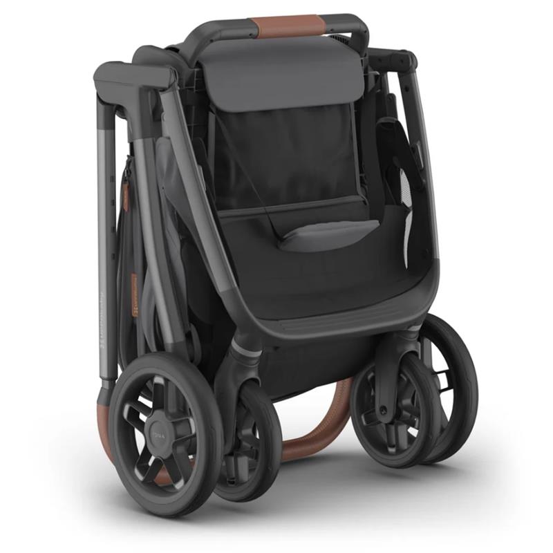 Uppababy Kona stroller in graphite color, featuring a sleek black seat and brown leatherette handle, folded for storage.