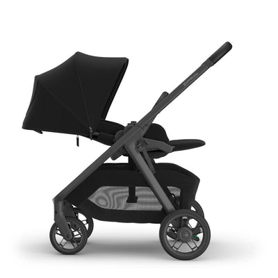 Uppababy Kona stroller in black with a carbon frame and leather accents, featuring a large canopy and spacious storage.