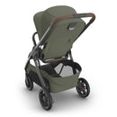 Uppababy Kona stroller in Meadow Green with a sleek design, adjustable seat, and a spacious storage basket.