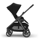 Uppababy Kona stroller in black with a large canopy, adjustable seat, and storage basket, showcasing a sleek design.