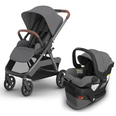Uppababy Kona stroller in grey with brown leatherette handles beside Mesa V3 infant car seat in matching grey.