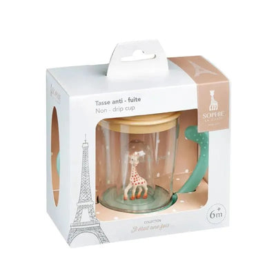 Non-drip cup featuring a colorful giraffe inside a transparent container, packaged with a handle and cardboard box.