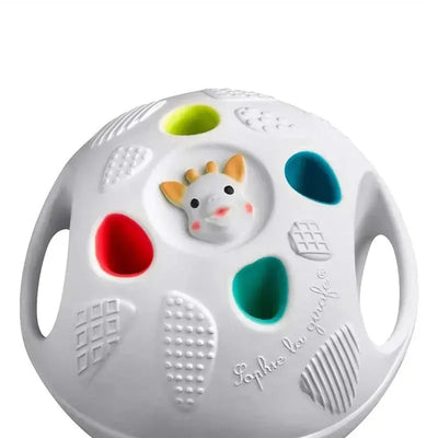Vulli Sophie La Girafe So Pure Senso Ball in white, featuring a textured surface with colorful cutouts and a giraffe face in the center.