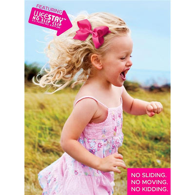 Medium light yellow hair bow from Wee Ones is worn by a joyful young girl running outdoors in a pink dress.
