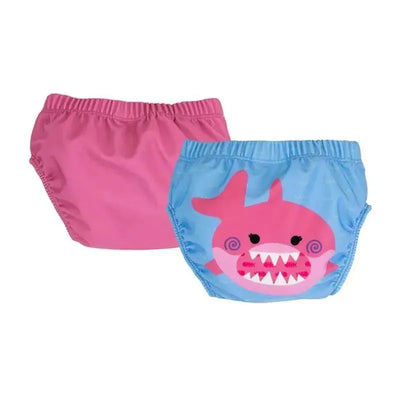 Two baby swim diapers in pink and blue, featuring a shark design with a smiling face and teeth.