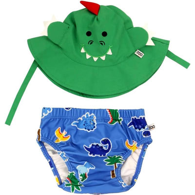 Green dinosaur-themed sun hat with face detailing and matching blue swim diaper featuring colorful dinosaur prints.