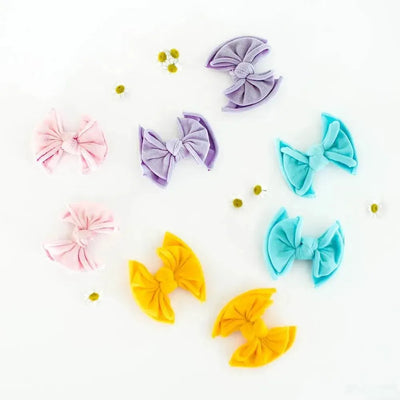 Assorted colorful Baby Bling Bows fabric hair clips for babies on a white background.