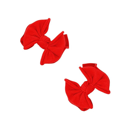 Two cherry red Baby Bling Bows fabric hair clips for babies on a white background