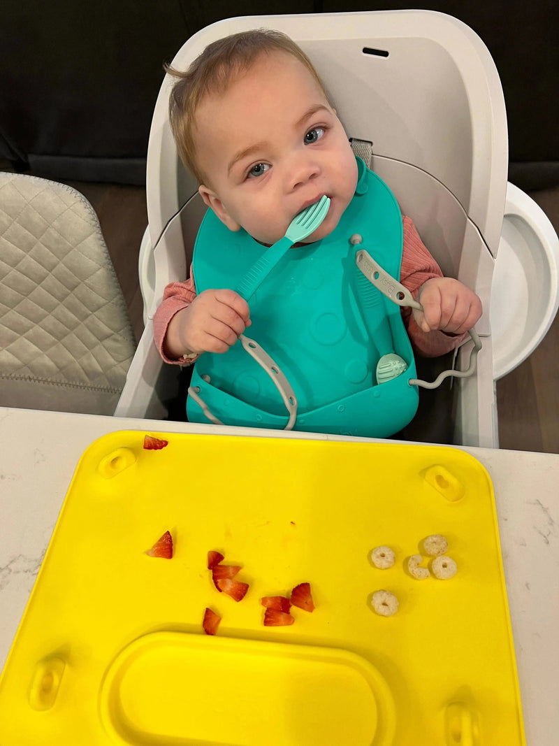 Conjunto de babador e utensílio para bebê ocupado